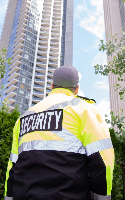 A security guard in uniform patrolling a residential area.