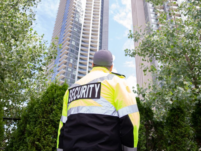 A security guard in uniform patrolling a residential area.