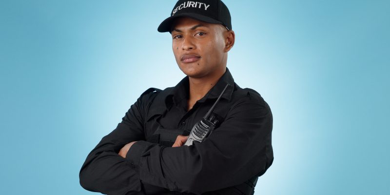 Security guard, portrait and man in studio with arms crossed, walkie talkie and surveillance of law.